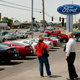A car salesman with a customer at a Ford dealership in Downers Grove, Illinois. Image: Getty